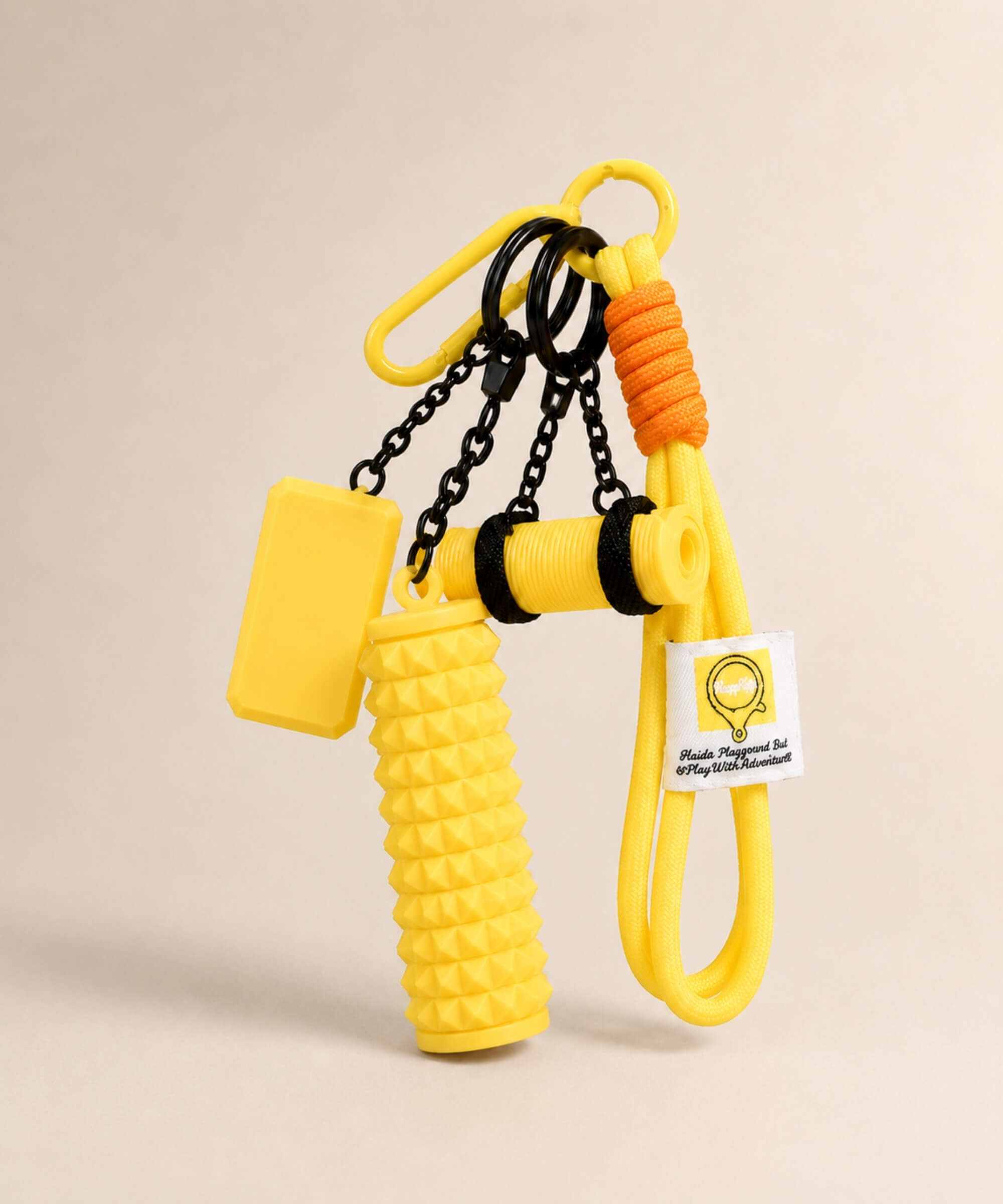 Yellow yoga rope keychain with mini foam roller charm on a neutral background